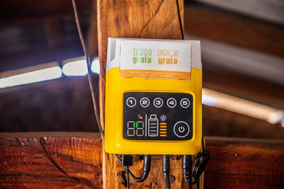 Solar technician installing a charge controller in a residential off-grid system